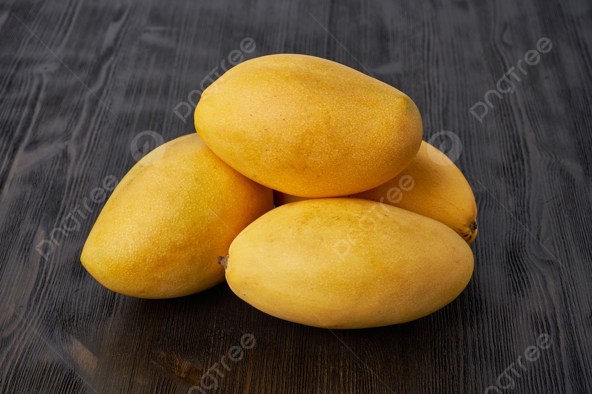 pngtree-four-luscious-whole-mangoes-resting-on-a-wooden-table-these-large-picture-image_13675261